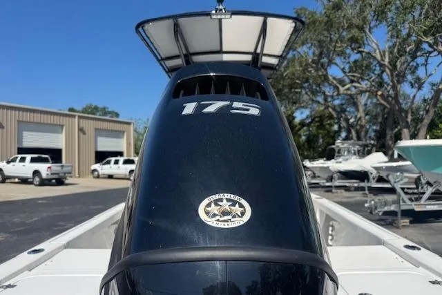 Slide: The Image of 2024 Sea Pro 210 Bay boat with 175 horsepower engine, parked outdoors. - 6