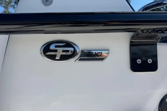 Slide: The Image of 2024 Sea Pro 210 Bay boat emblem on white surface, close-up view. - 9