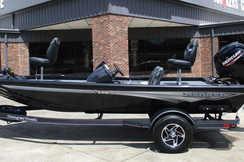 The Image of 2026 Ranger RT178 boat with Mercury engine, parked outside a brick building. - 1