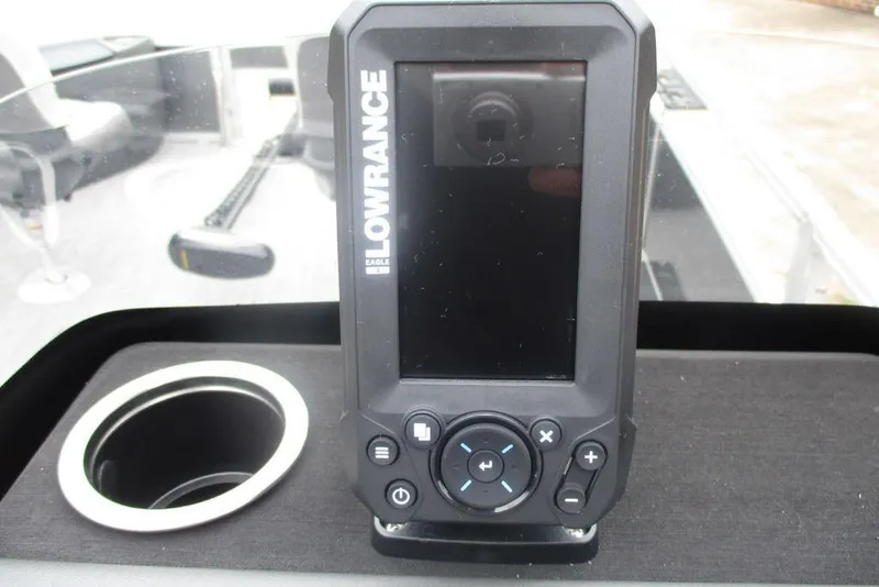 Slide: The Image of 2026 Sun Tracker Bass Buggy 18 DLX dashboard with steering wheel and Lowrance device. - 3