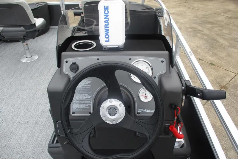 Slide: The Image of 2026 Sun Tracker Bass Buggy 18 DLX pontoon boat on trailer with Mercury outboard motor. - 4