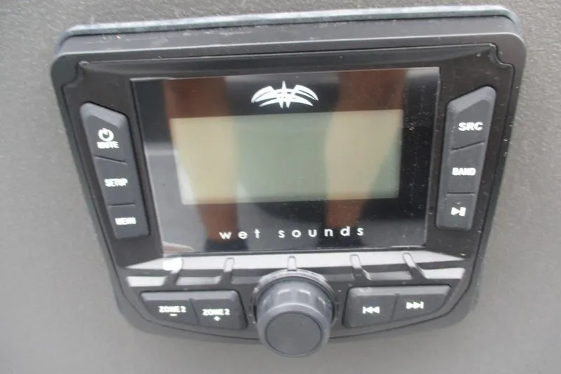 Slide: The Image of 2026 Sun Tracker Bass Buggy 18 DLX pontoon boat interior with seating and steering console. - 6