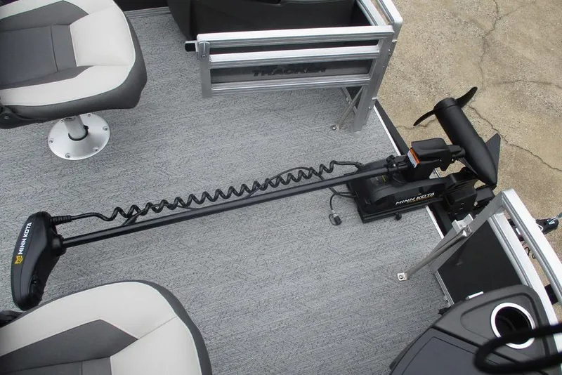 Slide: The Image of 2026 Sun Tracker Bass Buggy 18 DLX pontoon boat interior with gray seating and carpet. - 8