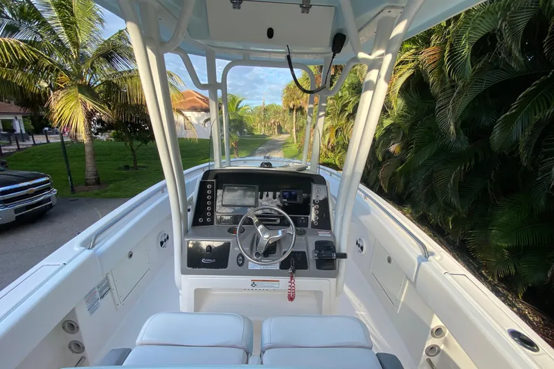 Slide: The Image of 2020 Robalo Center Console boat dashboard with steering wheel and navigation controls. - 19