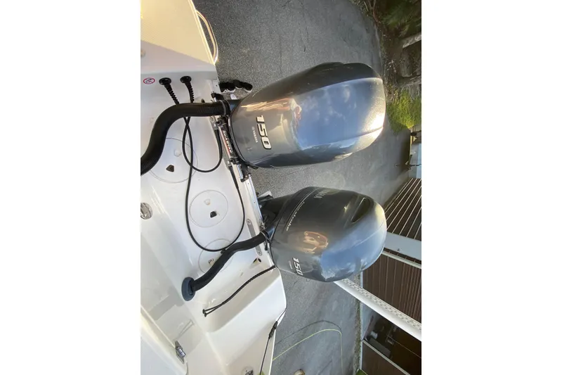 Slide: The Image of 2020 Robalo Center Console boat with Yamaha engine, parked on a sunny day. - 23