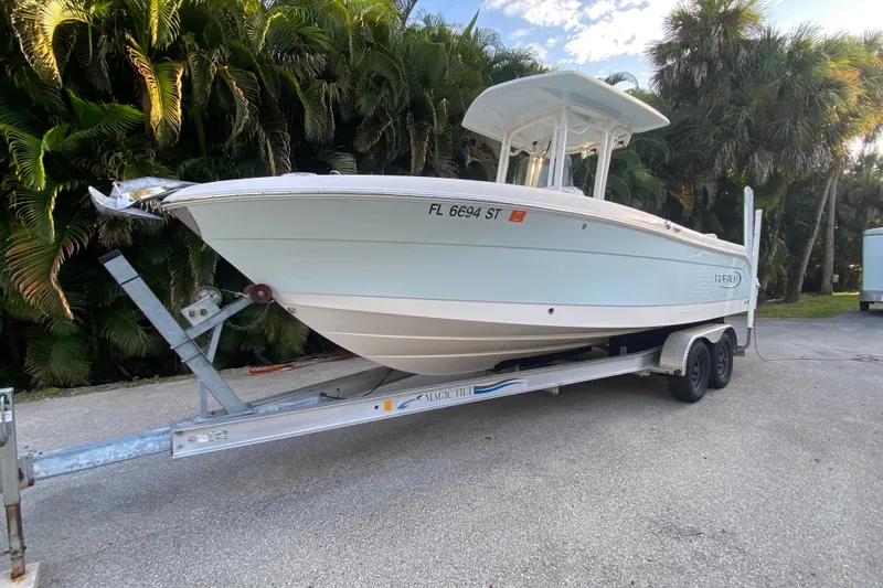 Slide: The Image of 2020 Robalo Center Console boat on trailer, surrounded by lush greenery. - 3