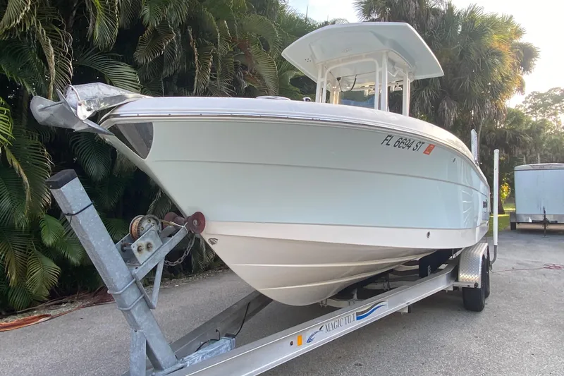 Slide: The Image of 2020 Robalo Center Console boat on trailer, surrounded by lush greenery. - 5