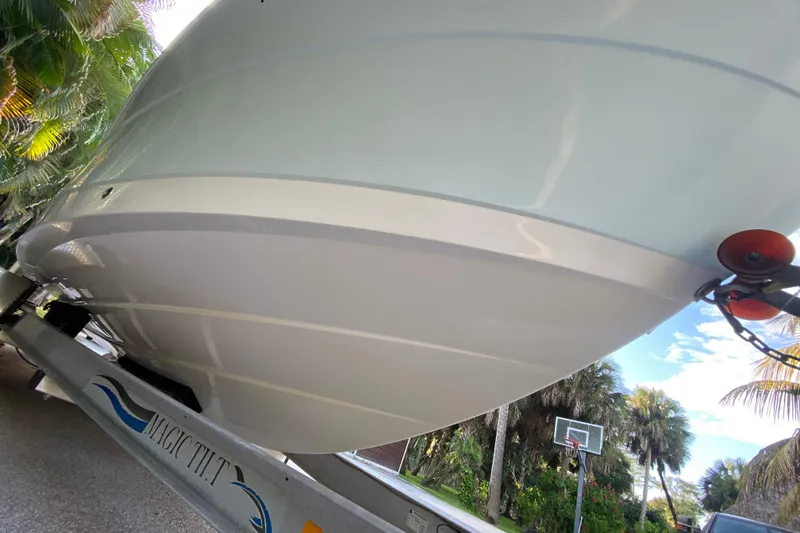 Slide: The Image of 2020 Robalo Center Console boat on trailer, surrounded by tropical foliage. - 7