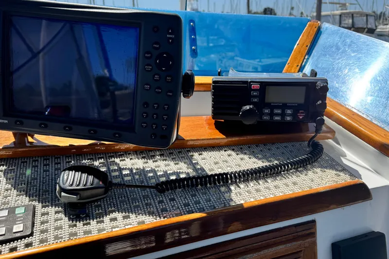 Slide: The Image of 1980 Californian Tri-Cabin Trawler dashboard with navigation and communication equipment. - 14