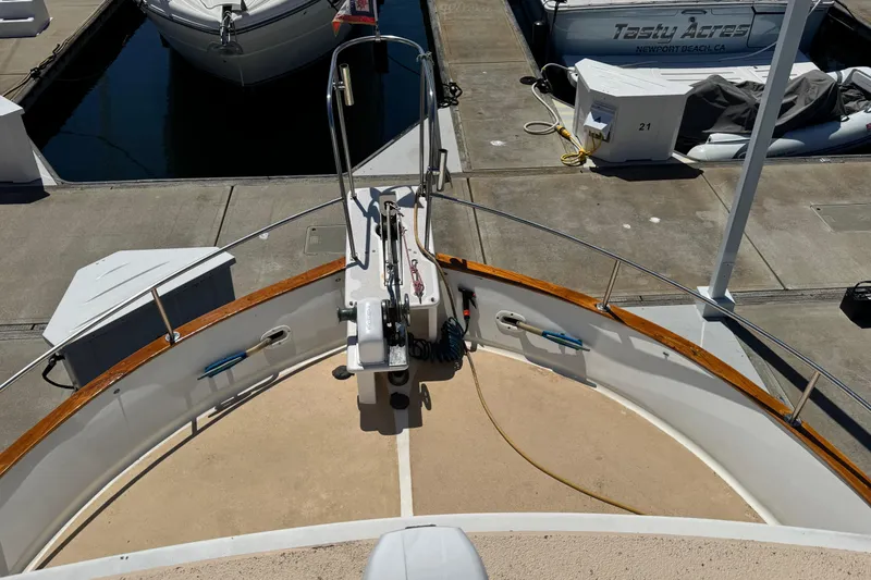 Slide: The Image of 1980 Californian Tri-Cabin Trawler bow view at marina dock. - 16