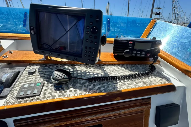 Slide: The Image of Control panel of a 1980 Californian Tri-Cabin Trawler with navigation and communication equipment. - 19