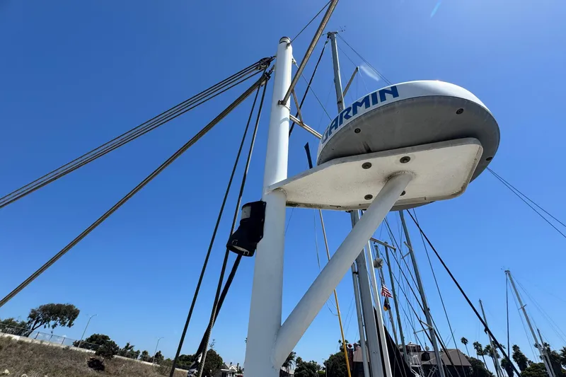 Slide: The Image of 1980 Californian Tri-Cabin Trawler mast with Garmin radar against clear blue sky. - 20