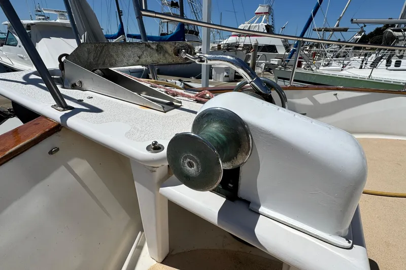 Slide: The Image of 1980 Californian Tri-Cabin Trawler deck with anchor winch and railing in marina. - 23