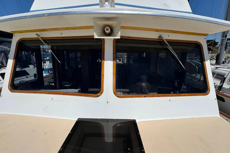 Slide: The Image of 1980 Californian Tri-Cabin Trawler front view with large windows and wipers. - 24