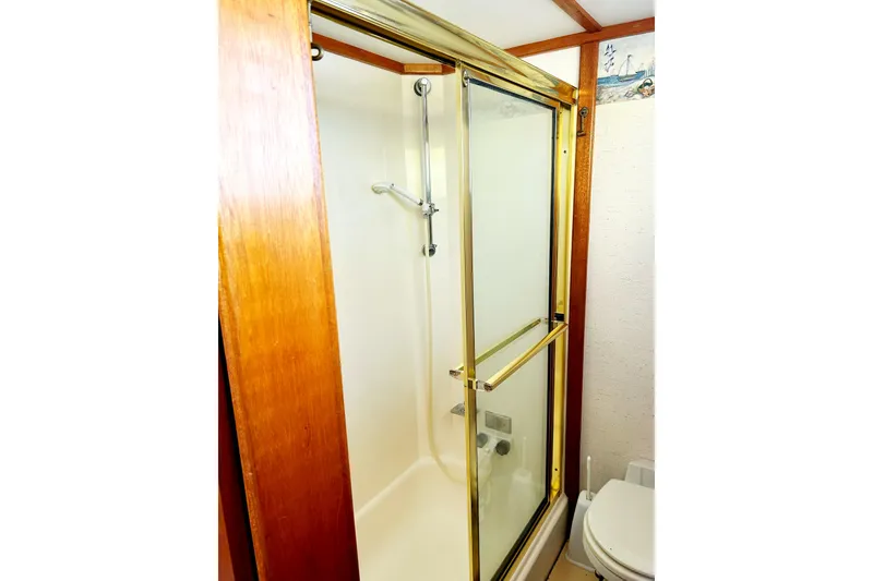 Slide: The Image of 1980 Californian 42 LRC yacht shower with glass door and wooden trim. - 29