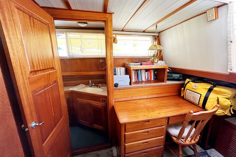 Slide: The Image of 1980 Californian 42 LRC yacht interior with wooden desk, chair, and bookshelf. - 30