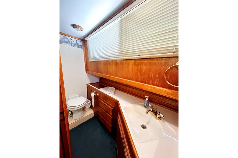Slide: The Image of 1980 Californian 42 LRC yacht bathroom with wooden cabinetry, sink, and toilet. - 32