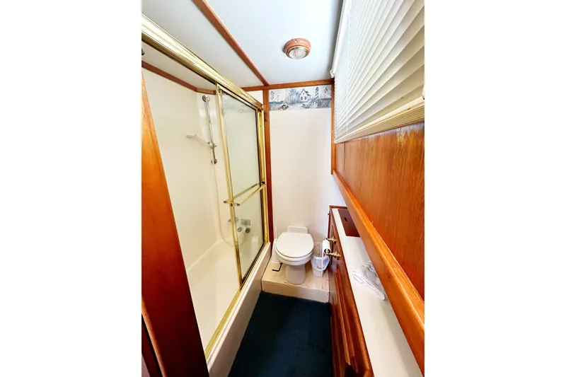 Slide: The Image of 1980 Californian 42 LRC yacht bathroom with shower, toilet, and wooden accents. - 33
