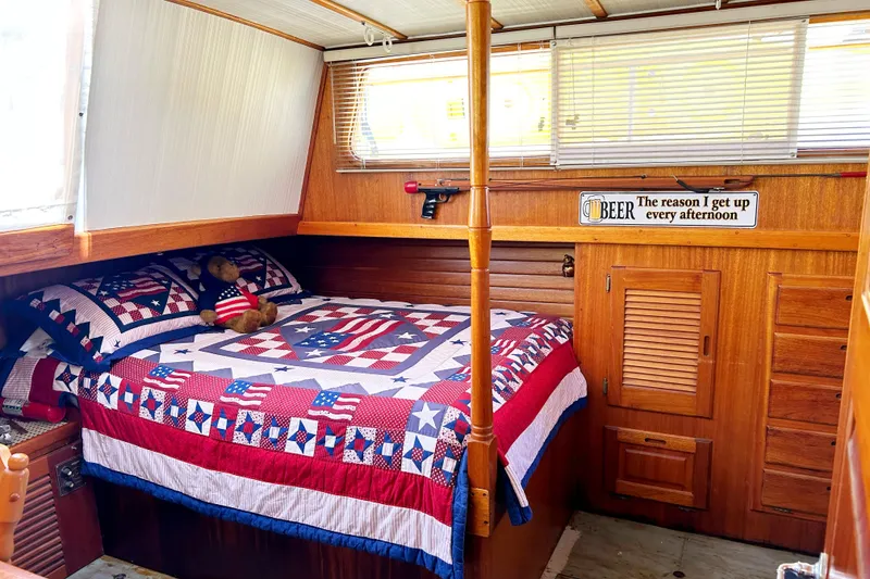 Slide: The Image of Cozy cabin interior of 1980 Californian 42 LRC with patriotic bedding and humorous beer sign. - 35