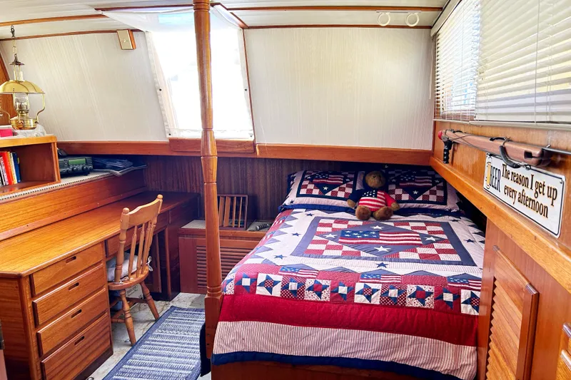 Slide: The Image of Cozy cabin interior of 1980 Californian 42 LRC with bed, desk, and nautical decor. - 37