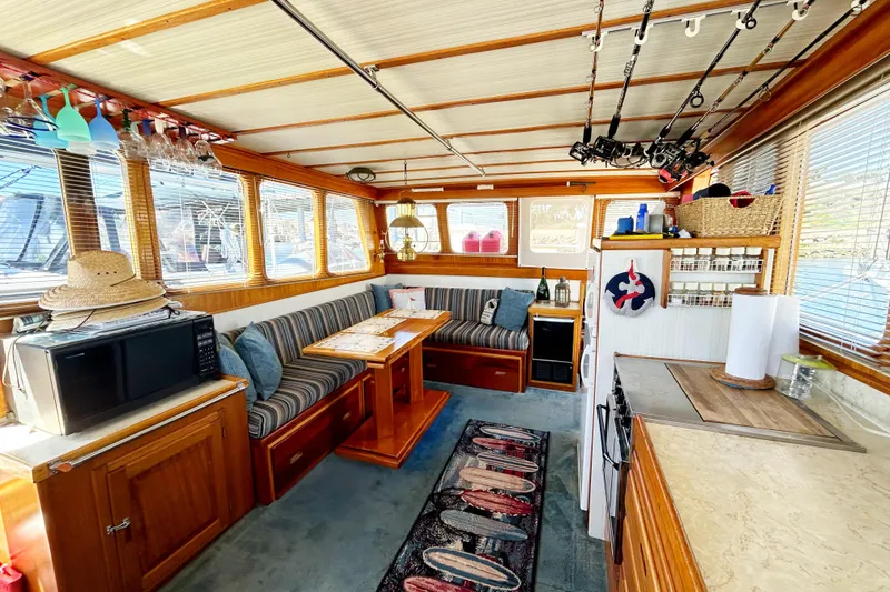 Slide: The Image of Interior of a 1980 Californian 42 LRC yacht with cozy seating and fishing rods. - 41
