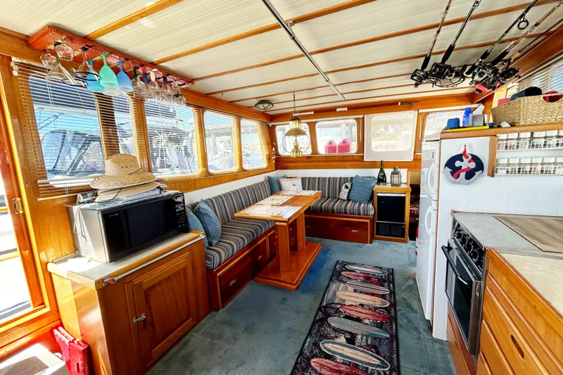 Slide: The Image of Interior of 1980 Californian 42 LRC yacht with cozy seating and kitchen area. - 42
