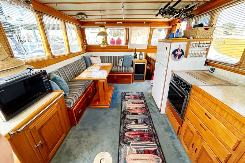 Slide: The Image of Interior of 1980 Californian 42 LRC yacht with cozy seating, kitchen, and nautical decor. - 43