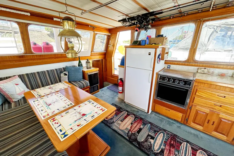 Slide: The Image of Interior of a 1980 Californian 42 LRC yacht with dining area and kitchen amenities. - 44