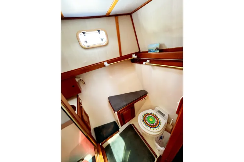 Slide: The Image of 1980 Californian 42 LRC yacht bathroom with colorful toilet seat and wooden accents. - 49