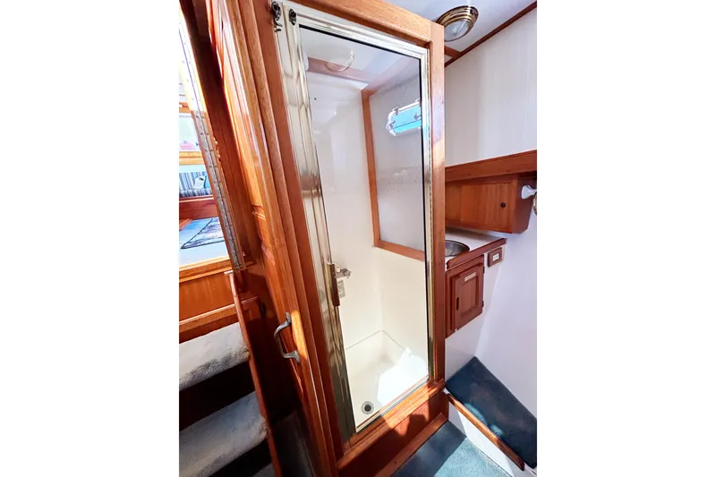 Slide: The Image of 1980 Californian 42 LRC yacht shower with wooden trim and glass door. - 50