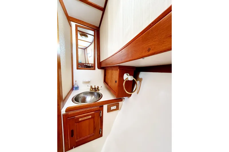 Slide: The Image of 1980 Californian 42 LRC yacht bathroom with wooden cabinetry and stainless steel sink. - 51
