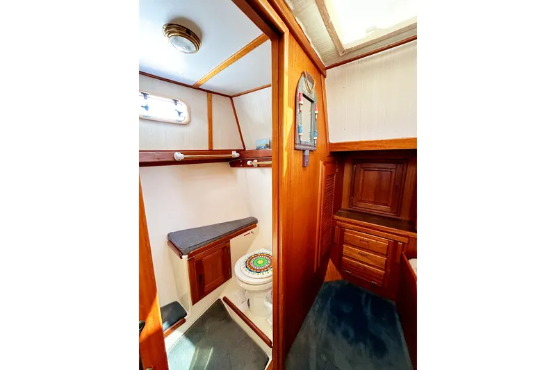 Slide: The Image of 1980 Californian 42 LRC yacht bathroom with wooden cabinetry and nautical decor. - 52