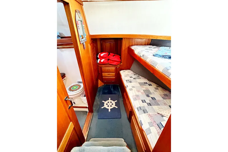Slide: The Image of Interior of 1980 Californian 42 LRC yacht with bunk beds and nautical decor. - 54