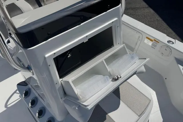 Slide: The Image of Open storage compartment on a 2026 Frontier 2104 boat, featuring organized interior space. - 13