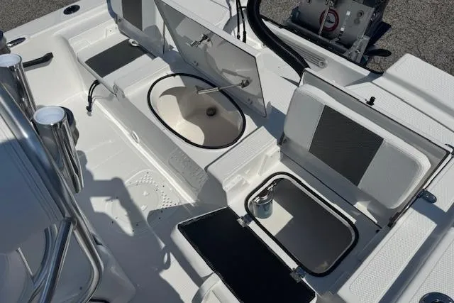 Slide: The Image of 2026 Frontier 2104 boat interior with open storage compartments and seating. - 17