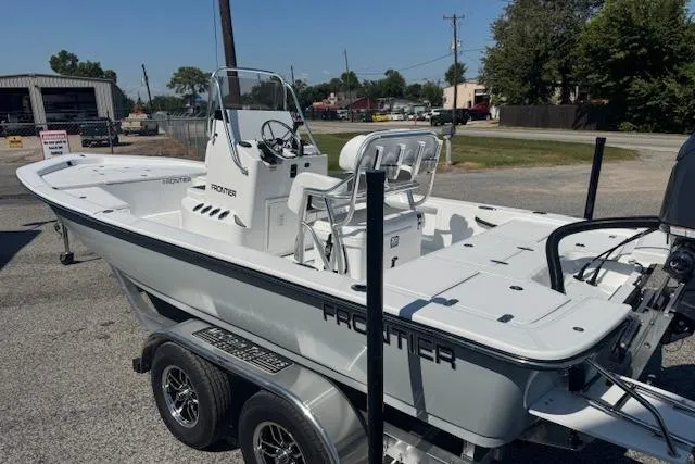 Slide: The Image of 2026 Frontier 2104 boat on trailer, parked outdoors, showcasing sleek design and modern features. - 3