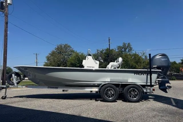 Slide: The Image of 2026 Frontier 2104 boat on trailer, side view, outdoors. - 5