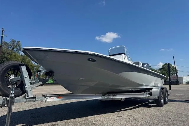 Slide: The Image of 2026 Frontier 2104 boat on trailer under clear blue sky. - 6