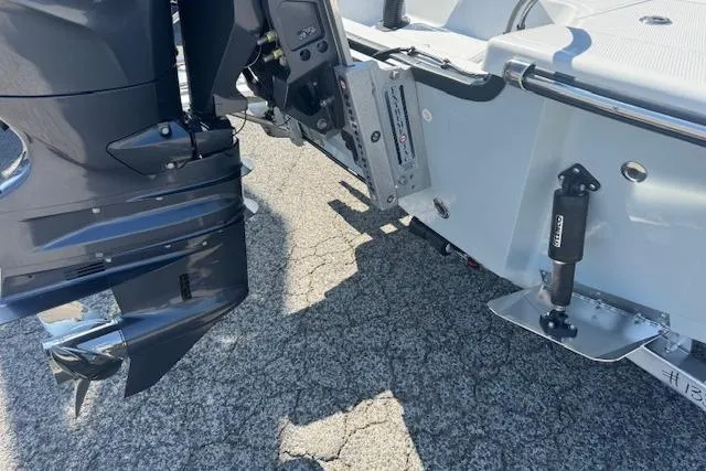 Slide: The Image of Outboard motor and trim tabs on a 2026 Frontier 2104 boat. - 7