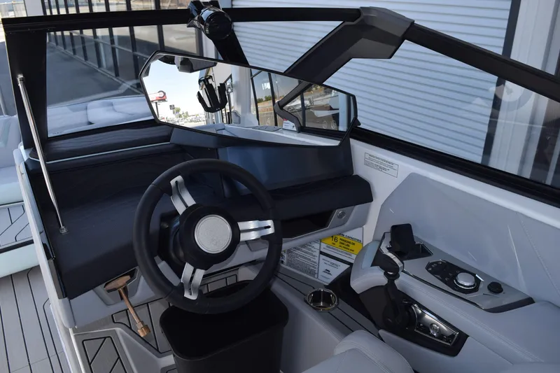 Slide: The Image of 2025 Nautique Super Air Nautique G23 Paragon cockpit with modern steering and controls. - 7