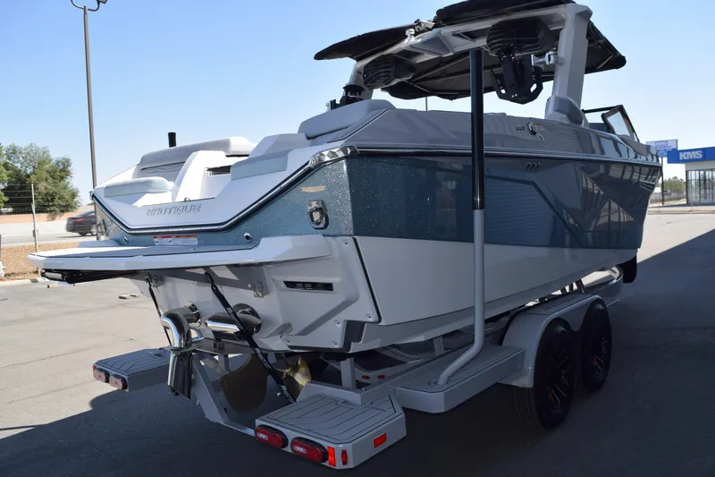 Slide: The Image of 2025 Nautique Super Air Nautique G23 Paragon boat on trailer, rear view. - 4
