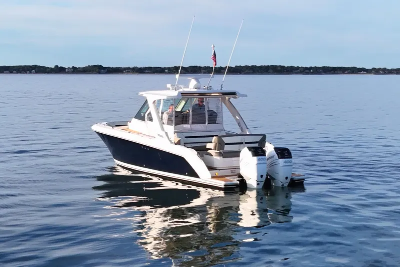 Slide: The Image of 2022 Tiara Yachts 34 LS cruising on calm waters with twin engines. - 10