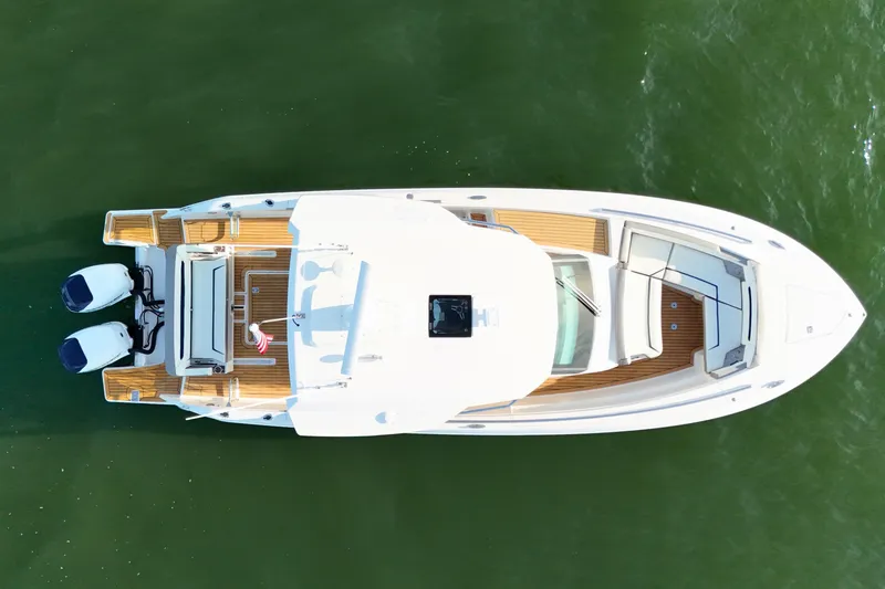 Slide: The Image of Overhead view of 2022 Tiara Yachts 34 LS on green water. - 12