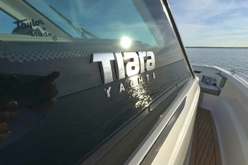 Slide: The Image of 2022 Tiara Yachts 34 LS on water, showcasing sleek design and branding. - 13