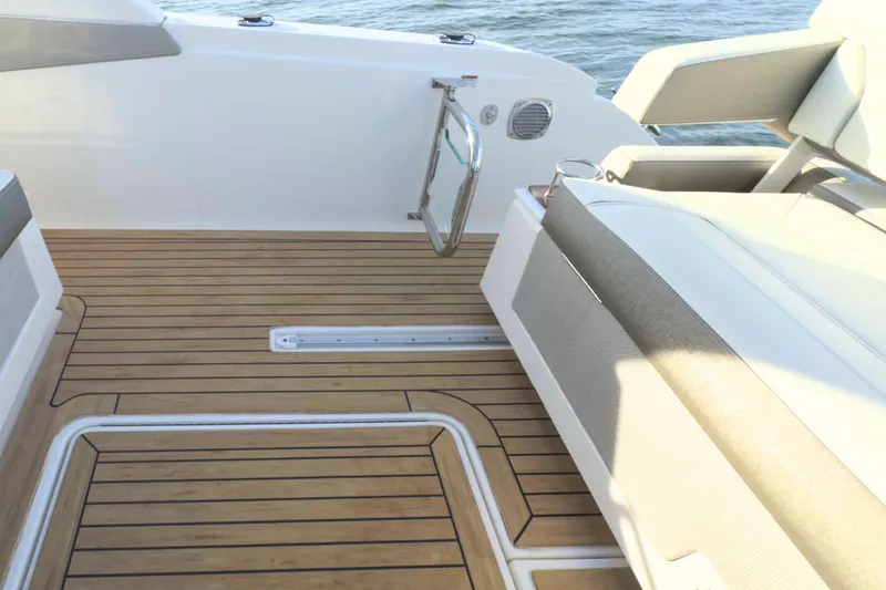 Slide: The Image of 2022 Tiara Yachts 34 LS boat deck with teak flooring and cushioned seating. - 15