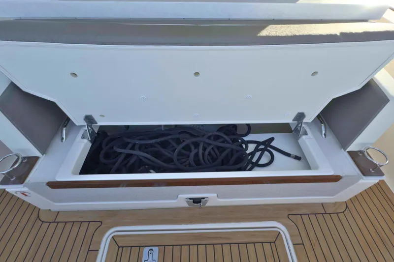Slide: The Image of Open storage compartment on 2022 Tiara Yachts 34 LS, containing coiled ropes. - 20