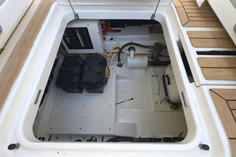 Slide: The Image of Engine compartment of 2022 Tiara Yachts 34 LS, showcasing batteries and electrical components. - 21