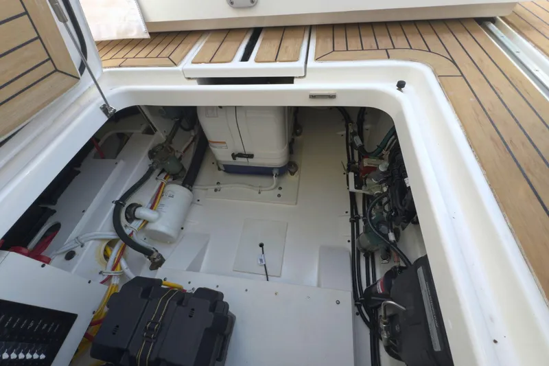 Slide: The Image of Engine compartment of 2022 Tiara Yachts 34 LS, showcasing mechanical components and wiring. - 22