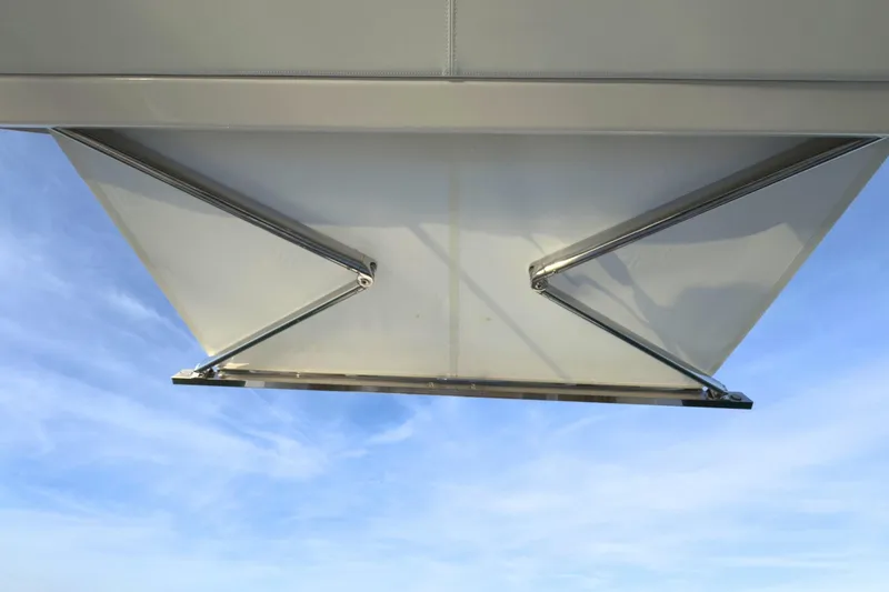 Slide: The Image of 2022 Tiara Yachts 34 LS retractable awning against blue sky. - 25