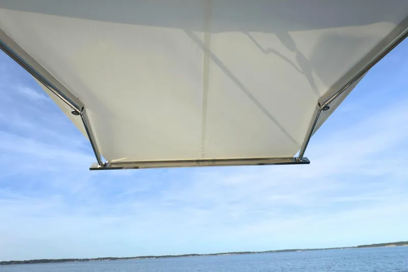 Slide: The Image of Tiara Yachts 34 LS 2022 boat canopy with ocean view and clear sky. - 26